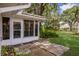 Backyard with a tiled patio and manicured landscaping surrounding the home at 5712 Garden Lakes Dr, Bradenton, FL 34203