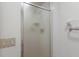 This bathroom includes a frosted glass shower door, white fixtures, and a towel rack at 5712 Garden Lakes Dr, Bradenton, FL 34203