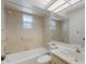 Bathroom featuring a tub, shower combination, and a large mirror above the sink and vanity at 5712 Garden Lakes Dr, Bradenton, FL 34203