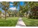 Walking path through a verdant community with mature trees and well-kept lawns at 5712 Garden Lakes Dr, Bradenton, FL 34203