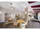 Spacious dining area featuring hardwood floors, community fireplace, and open floorplan at 5712 Garden Lakes Dr, Bradenton, FL 34203
