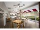 Community dining area with hardwood floors, brick pillar accents, and lots of natural light at 5712 Garden Lakes Dr, Bradenton, FL 34203