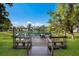 Wooden dock overlooking a serene lake with patio furniture, perfect for outdoor enjoyment at 5712 Garden Lakes Dr, Bradenton, FL 34203