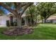 Charming home featuring a two-car garage, red tile roof, and mature trees at 5712 Garden Lakes Dr, Bradenton, FL 34203