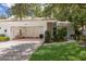 Charming home featuring a two-car garage, red tile roof, and well-manicured landscaping at 5712 Garden Lakes Dr, Bradenton, FL 34203