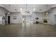 Large hall featuring neutral paint, ceiling fans, and a stone fireplace, perfect for gatherings at 5712 Garden Lakes Dr, Bradenton, FL 34203