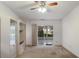 Spacious living room featuring built-in cabinets, carpeted floors, and sliding glass doors at 5712 Garden Lakes Dr, Bradenton, FL 34203
