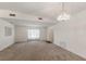Spacious living room with neutral walls, carpeted flooring, and natural light from a large window at 5712 Garden Lakes Dr, Bradenton, FL 34203