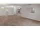 Spacious living room with neutral walls, carpeted flooring, and built-in display cabinets at 5712 Garden Lakes Dr, Bradenton, FL 34203