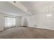 Spacious living room with neutral walls, carpeted flooring, and natural light from a large window at 5712 Garden Lakes Dr, Bradenton, FL 34203