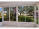 Enclosed sunroom with tile flooring and large windows offering views of the surrounding landscape at 5712 Garden Lakes Dr, Bradenton, FL 34203