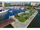 Waterfront community area with a gazebo, lounge chairs, and boat docks surrounded by lush vegetation at 5855 Midnight Pass Rd # 621, Sarasota, FL 34242