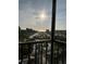 Stunning water view from the balcony with a pond, palm trees, and community at 5855 Midnight Pass Rd # 621, Sarasota, FL 34242