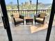 Inviting balcony featuring comfortable seating and serene views of lush landscaping and water at 5855 Midnight Pass Rd # 621, Sarasota, FL 34242
