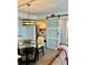 Cozy dining area with a glass-top table and modern light fixture, adjacent to the kitchen at 5855 Midnight Pass Rd # 621, Sarasota, FL 34242