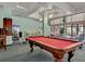 Spacious game room with red pool table, comfortable couches, ceiling fans, and access to tables and chairs at 5855 Midnight Pass Rd # 621, Sarasota, FL 34242