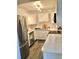 Modern kitchen with stainless steel appliances, white cabinets, and quartz countertops at 5855 Midnight Pass Rd # 621, Sarasota, FL 34242