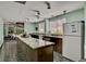 Bright kitchen with white appliances, large island with granite countertops, and tile flooring at 5855 Midnight Pass Rd # 621, Sarasota, FL 34242