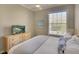 Bright bedroom with a large window and comfortable bed, TV on the dresser at 5877 Ferrara Dr, Sarasota, FL 34238