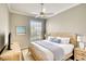Cozy bedroom offers soft lighting and a comfortable bed with a beach house themed pillow at 5877 Ferrara Dr, Sarasota, FL 34238