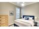 Comfortable bedroom with a blue headboard bed, stylish decor, and a large window at 5877 Ferrara Dr, Sarasota, FL 34238