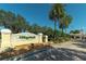 Inviting entrance to VillageWalk with lush landscaping and a charming clock tower, welcoming residents and visitors at 5877 Ferrara Dr, Sarasota, FL 34238