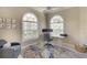 Cozy home office featuring arched windows, natural light, and comfortable seating at 5877 Ferrara Dr, Sarasota, FL 34238