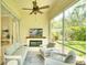 Relaxing screened lanai with comfortable seating, fireplace, and serene backyard views at 5877 Ferrara Dr, Sarasota, FL 34238