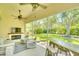 Relaxing screened lanai with comfortable seating, fireplace, and beautiful backyard views at 5877 Ferrara Dr, Sarasota, FL 34238