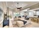 Open living room with a large sectional sofa, modern decor, and views of the dining area and kitchen at 5877 Ferrara Dr, Sarasota, FL 34238