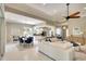 Open-concept living room, dining area, and kitchen with modern decor and ample natural light at 5877 Ferrara Dr, Sarasota, FL 34238