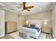 Spacious bedroom with a ceiling fan, wood floors, neutral walls, and dual nightstands at 5877 Ferrara Dr, Sarasota, FL 34238