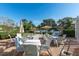 An outdoor patio with tables and chairs overlooking a serene lake, perfect for outdoor dining and entertaining at 5877 Ferrara Dr, Sarasota, FL 34238