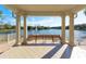 Covered outdoor seating area with a lake view, offering a relaxing space to enjoy the scenery at 5877 Ferrara Dr, Sarasota, FL 34238