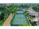 Aerial view of property with pickleball and tennis courts surrounded by tropical landscaping at 5916 Midnight Pass Rd # 404, Sarasota, FL 34242