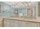 Bright bathroom features vanity with stone countertop, modern lighting, large mirror, and tiled walls at 5916 Midnight Pass Rd # 404, Sarasota, FL 34242