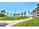 Beach access through landscaped grounds and common green space at 5916 Midnight Pass Rd # 404, Sarasota, FL 34242