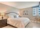 Comfortable bedroom featuring neutral walls, tile flooring, and a window with blinds and cornice at 5916 Midnight Pass Rd # 404, Sarasota, FL 34242
