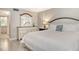 Bedroom with neutral walls, tile flooring, a bed, and a dresser with a mirror at 5916 Midnight Pass Rd # 404, Sarasota, FL 34242