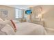 Comfortable bedroom featuring twin beds, an accent chair, and a mounted television at 5916 Midnight Pass Rd # 404, Sarasota, FL 34242
