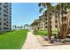 Path to beach between condo buildings through landscaped lawns at 5916 Midnight Pass Rd # 404, Sarasota, FL 34242