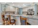 Stylish kitchen with granite countertops, stainless steel appliances, and breakfast bar seating at 5916 Midnight Pass Rd # 404, Sarasota, FL 34242