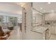 Open-concept kitchen with granite countertops, stainless appliances, and an inviting view into the living area at 5916 Midnight Pass Rd # 404, Sarasota, FL 34242