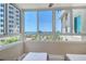 Inviting sunroom featuring ocean views, with seating, and screened windows allowing for natural light at 5916 Midnight Pass Rd # 404, Sarasota, FL 34242