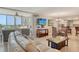 Bright living room with ocean view through a screened-in lanai, comfortable seating, and an adjacent dining area at 5916 Midnight Pass Rd # 404, Sarasota, FL 34242