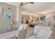 Open floorplan living area with ample natural light, comfortable seating, and stylish decor in neutral tones at 5916 Midnight Pass Rd # 404, Sarasota, FL 34242
