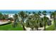 Lush palm trees surround a sparkling pool and a white sandy beach beyond; a beautiful ocean view at 5916 Midnight Pass Rd # 404, Sarasota, FL 34242