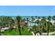 Lush landscaping surrounds a sparkling pool and white sand beach; beautiful ocean view at 5916 Midnight Pass Rd # 404, Sarasota, FL 34242