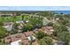 Aerial view showcasing neighborhood homes near the water and a golf course at 6207 Courtside Dr # 23, Bradenton, FL 34210