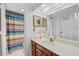 Bright bathroom with vanity, sink, and colorful shower curtain at 6207 Courtside Dr # 23, Bradenton, FL 34210